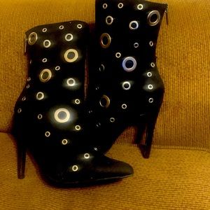 Brand new grommet styled boots Faux leather, zippered back